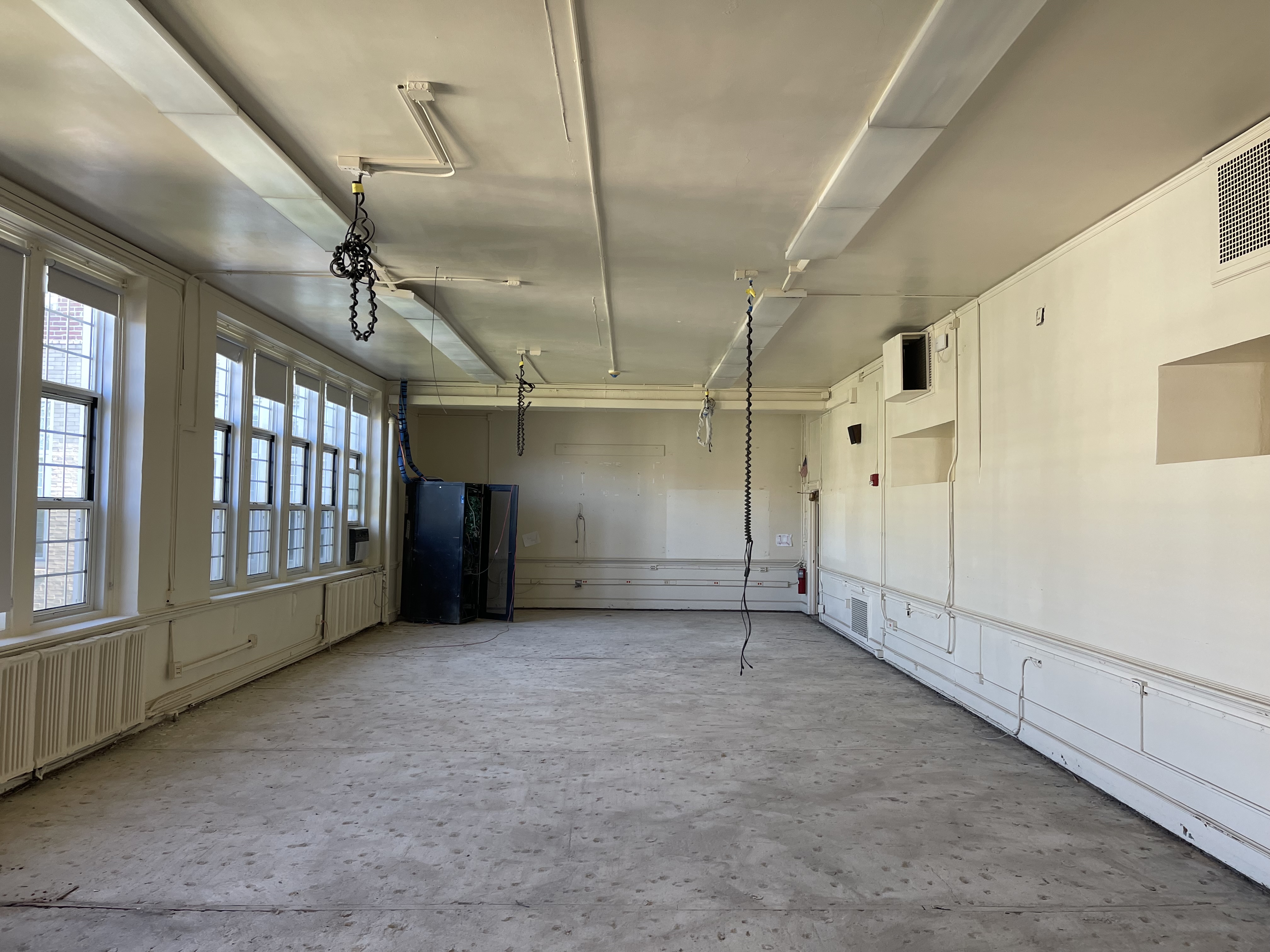 Before photo of classroom with old fluorescent lighting needing upgrade